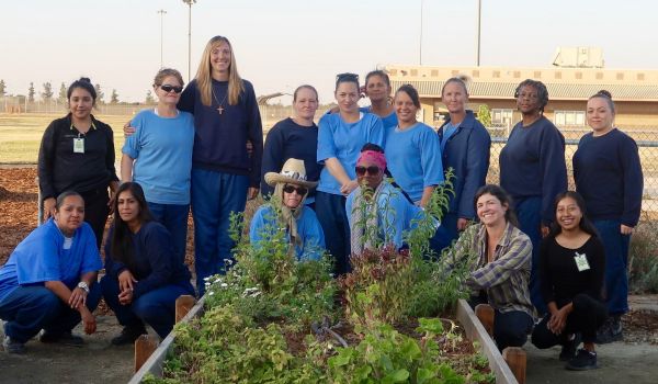 Incarcerated people with plants they gardened