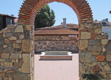 An ancient archway leading to the courtyard of the historic town, showcasing its timeless charm and rich heritage.