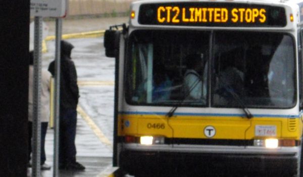 A person boarding an MBTA bus in Boston