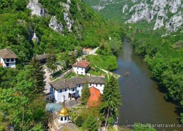 A scenic view of the village of Sveti Gora surrounded by lush greenery and rolling hills.