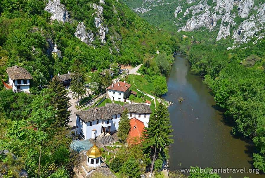 A scenic view of the village of Sveti Gora surrounded by lush greenery and rolling hills.