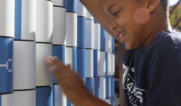 A child playing at the Urban Thinkscape lot in Philly's Belmont neighborhood