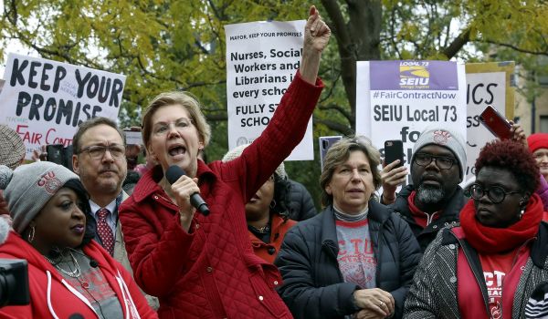 Democratic presidential candidate Elizabeth Warren calls for people across the country to support striking Chicago teachers after joining educators picketing outside an elementary school, Tuesday, Oct. 22, 2019, in Chicago. (AP Photo/Teresa Crawford)