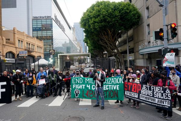 A crowd of protesters hold signs