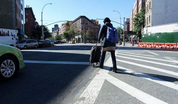 Person walks across a street in Brooklyn