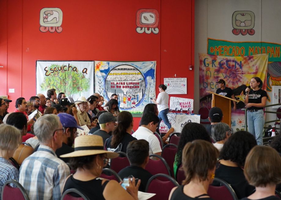 Ana Fuentes speaks on stage to a crowd of people