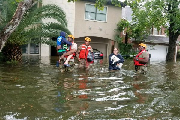 Residents leave their homes amid floods.