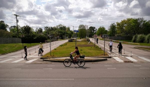 Woman rides bike in New Orleans.