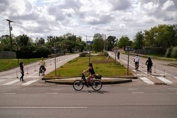 Woman rides bike in New Orleans.