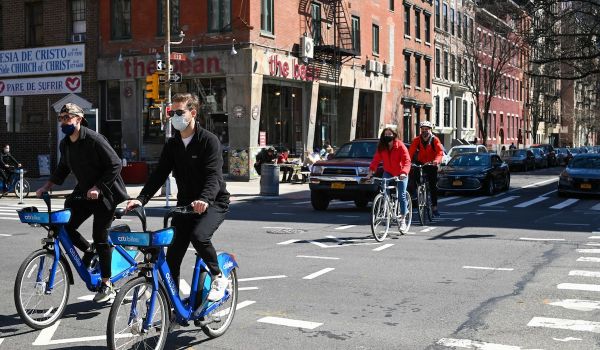 People bicycle in New York City street