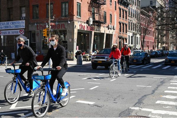 People bicycle in New York City street