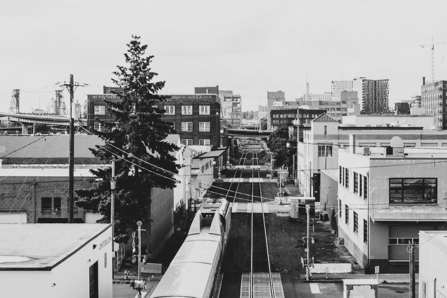 Industrial district in Portland, Oregon; train moves through rows of buildings on either side