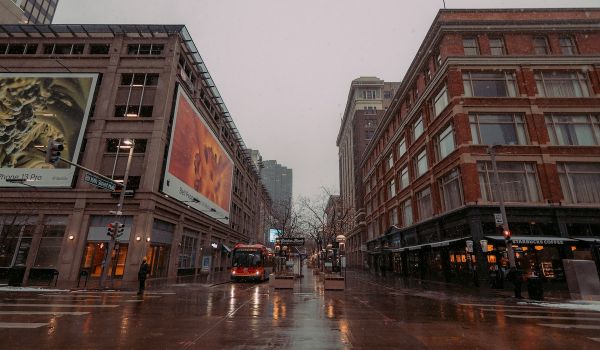 Bus drives down the street near commercial buildings in Denver