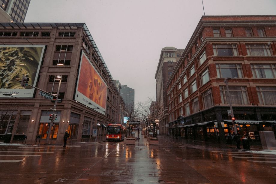 Bus drives down the street near commercial buildings in Denver