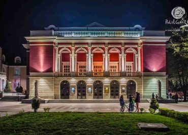 The city theatre illuminated at night, showcasing its grandeur and inviting ambiance.