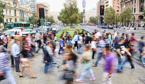 Residents walking on a sidewalk in Chile